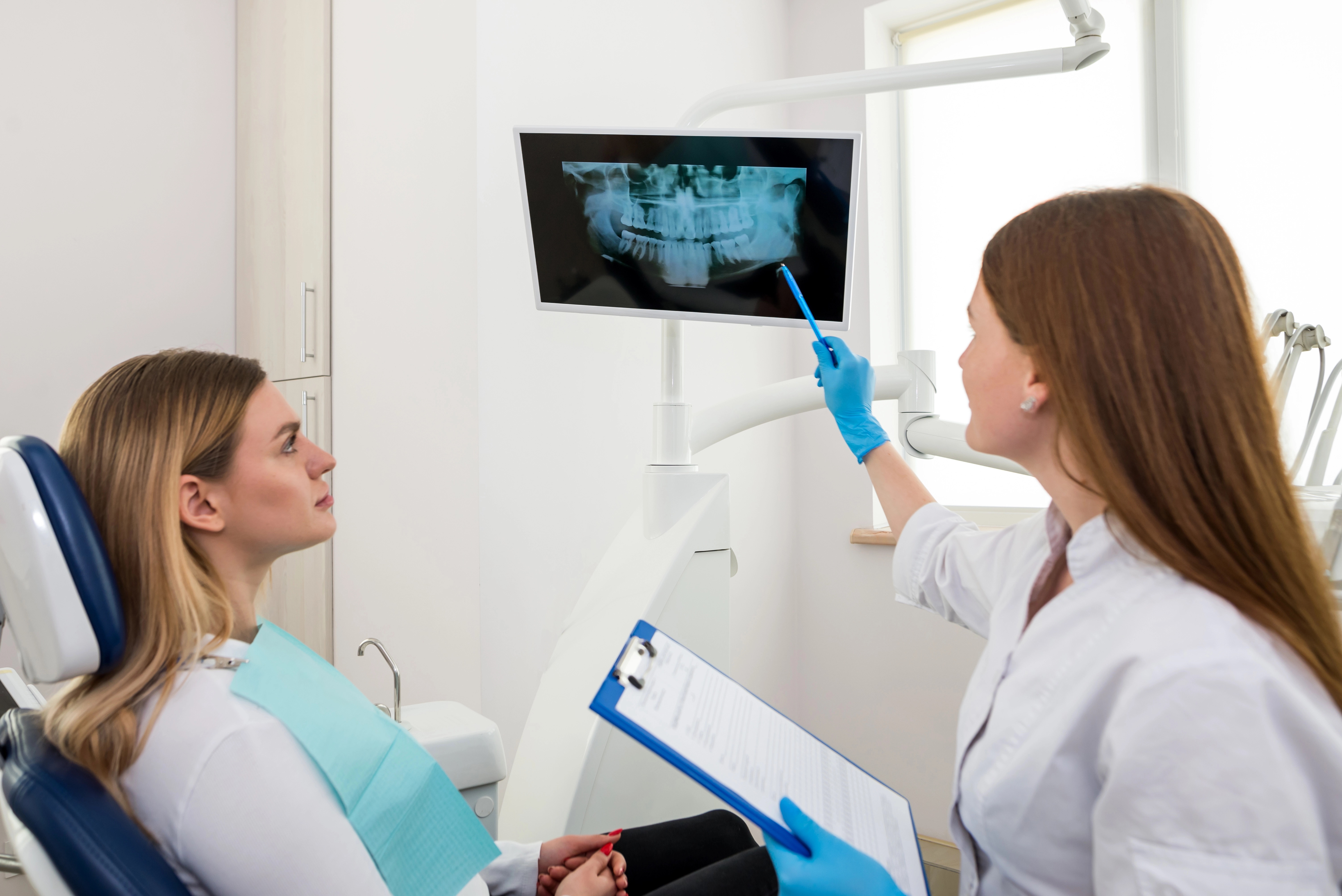 Dentist speaking with a patient during a preventive visit